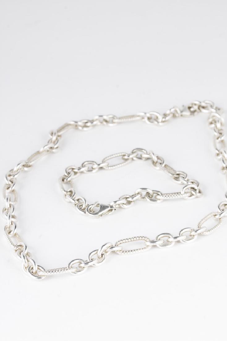 Sterling Cuban Style Chain Necklace and Bracelet: Cuban link style chain necklace in sterling, 18" in length. 38.27gms. Cuban link style chain bracelet. Approx 7.25" 14.72gms.