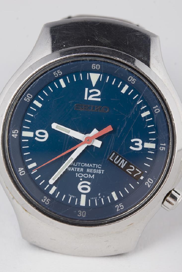 SEIKO 7S26A 21 Jewel Automatic Wristwatch: Vintage Seiko 7S26A 21 jewel automatic wristwatch with day/date at 4 position. Unique offset crown also at 4 position. Polished sterling silver case with royal blue tone dial and white Arabic numerals