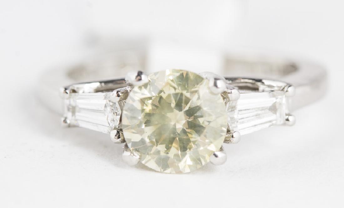 JEFF COOPER 1Ct Yellow Diamond & Platinum Ring: 1.0 carat light yellow diamond (6.4mm, SI1), set in platinum, by designer Jeff Cooper. Center diamond is flanked by 2 natural, emerald cut diamonds. 1.3CTW. Size 4.75. Weight 4.3 gms