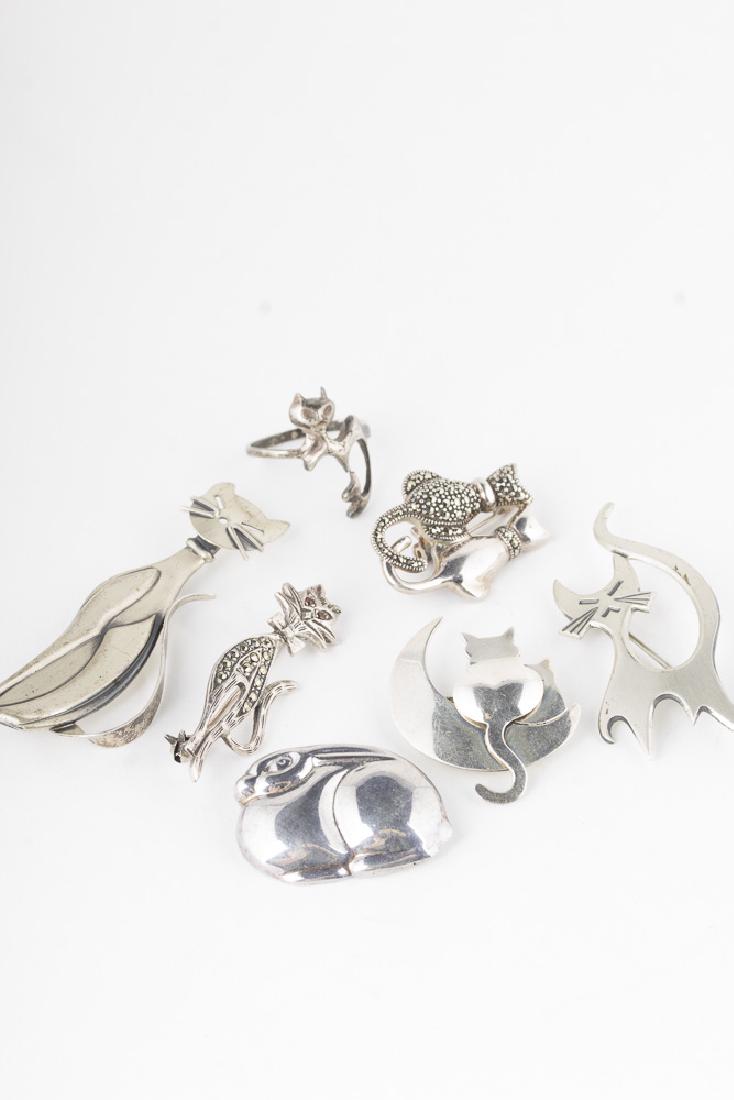 Collection of Sterling and Marcasite Cat Jewelry, some: 3 sterling single cat pins ranging from 1.5" to 2.5" in height, 2 sterling cat couple pins, both about 1.25" in height, size 7 sterling cat ring, and as a bonus a sterling bunny pin 1.25" x 0.75" 32.2