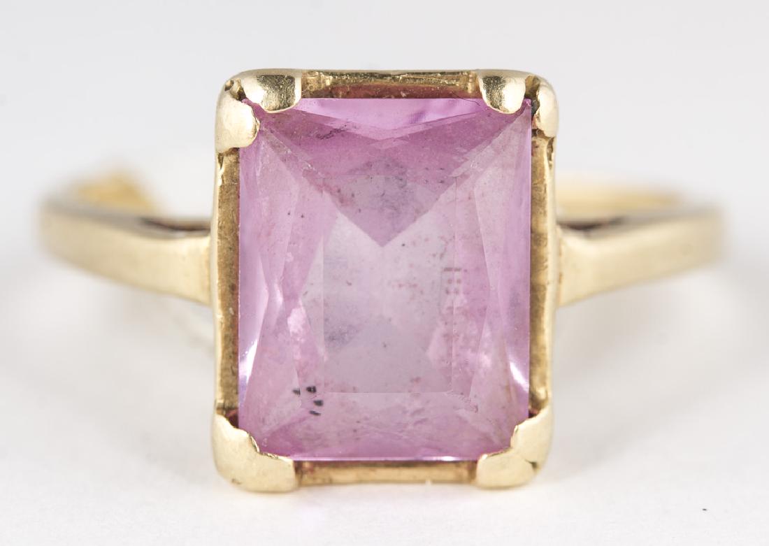 Square Cut Pink Stone Ring 14KT Yellow Gold: Emerald Cut Pink Stone Ring 10KT Yellow Gold. Size 6.5. 2.3g. Emerald cut Pink Stone 9.5mm long x 8.4mm wide.