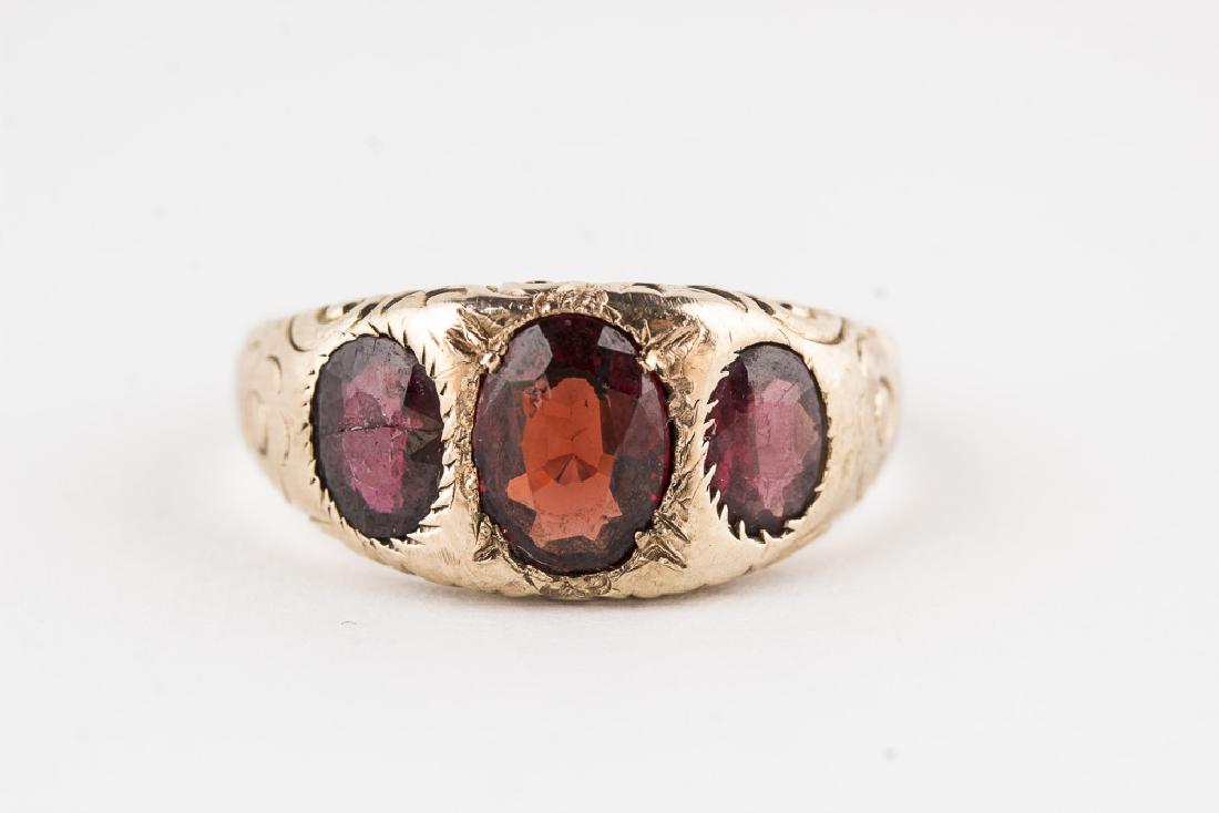 Garnet Ring 10KT Yellow Gold: Garnet Ring 10KT Yellow Gold. 4.7g. Size 7.75. Largest Stone 7.5mm x 6mm. 3 garnets set in 10KT Yellow Gold, the largest is the center stone measuring 2.5mm x 6mm.