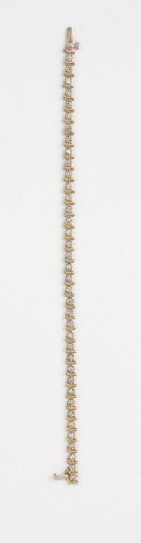 Diamond Tennis Bracelet 14KT Yellow Gold: Diamond Tennis Bracelet 14KT Yellow Gold. 7in length., 7.5g. Features 40 Diamonds 1ctw.