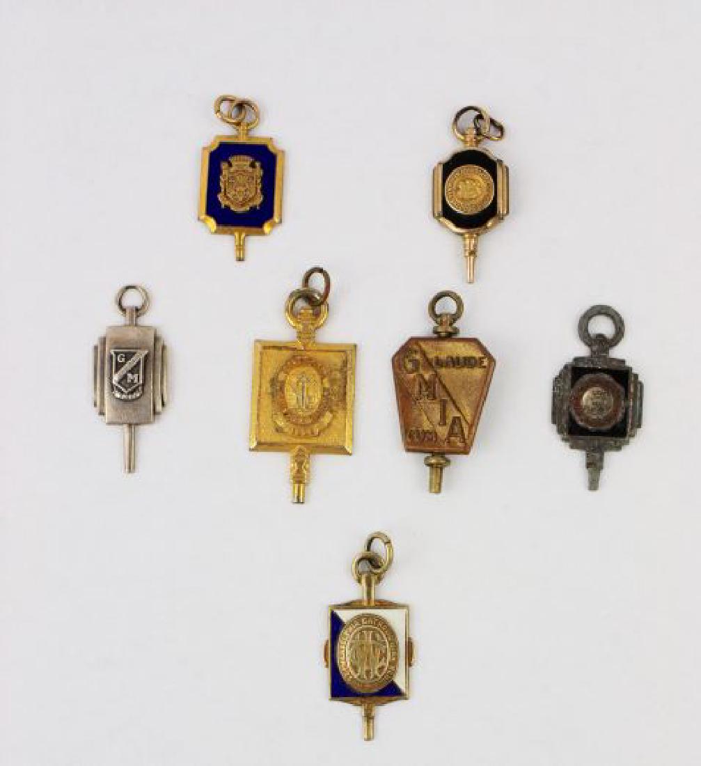 Lot of 7 School Key Charms: Lot of seven school key charms, either gold filled or sterling, representing various schools such as Baltimore Polytechnic, West Philadelphia Catholic, GMIA, and others. 33.34gms