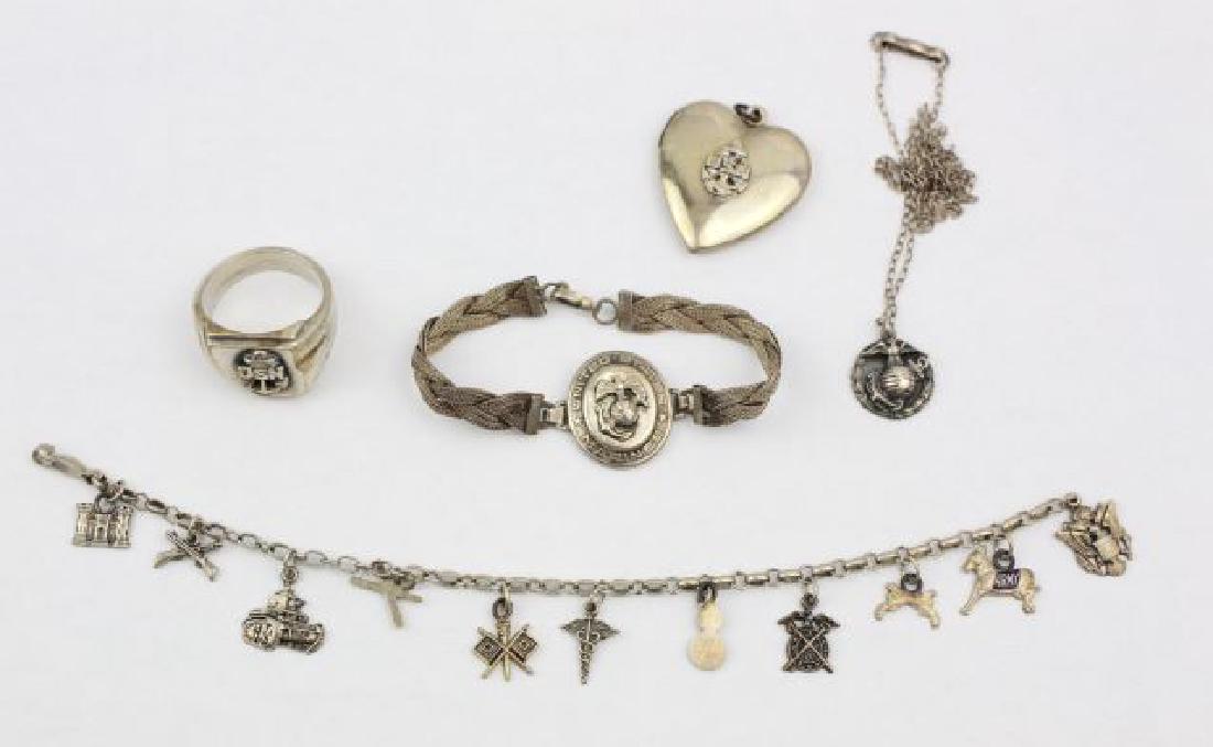 Military Jewelry Collection in Sterling: Collection contains the following: 7" Army themed charm bracelet with 11 charms, including thhe Army Mule; USNavy ring in sterling, size 9.5; USN heart locket, approx 1" in length; USMC emblem, approx