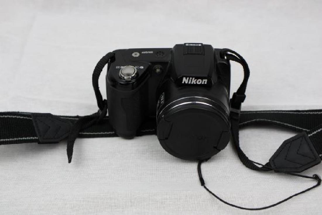 Nikon Cool Pix L110 w/ Strap: Nikon Cool Pix w/ Strap. 15x optical zoom, 12.1 Mega Pixels, 3.0in LCD Viewing Screen, HD Movie Capabilities w/ built in Microphone. Takes 4 "AA" Bateries w/ low battery indicator, Zoom in / Fade out