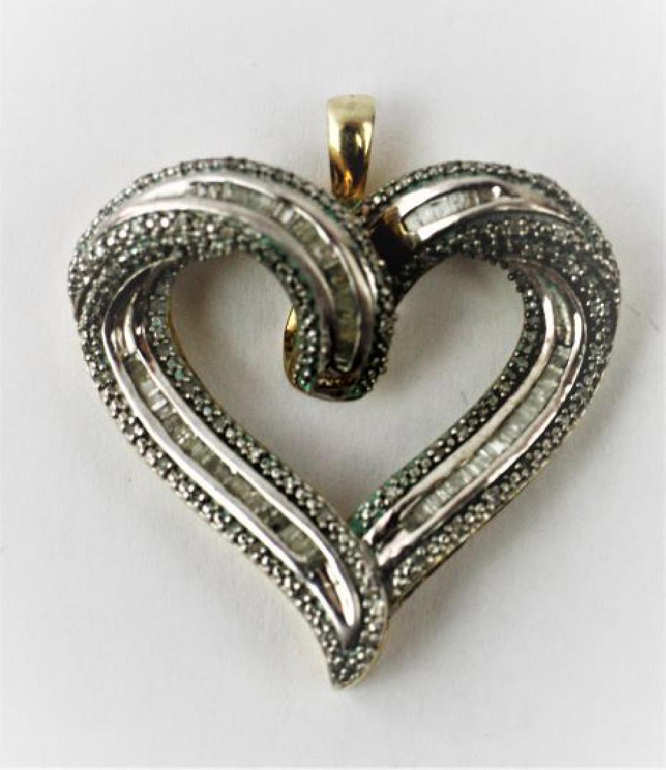 Sterling Silver Heart Pendant: Silver and Gold tone sterling siver heart pendant w/baguette and accent diamonds covering front,1.5in x 1.25in. Openwork scroll design on sides in gold tone. 8.7g
