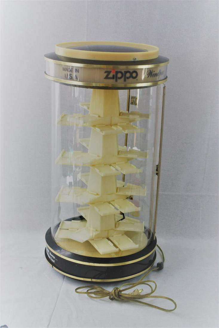 Rotating Zippo Lighter Display: Presented is an approximately 24" high rotating ZIPPO lighter display/sale case with specially designed shelves to hold 36 ZIPPO lighters in a continuously rotating display. Case has an approximately