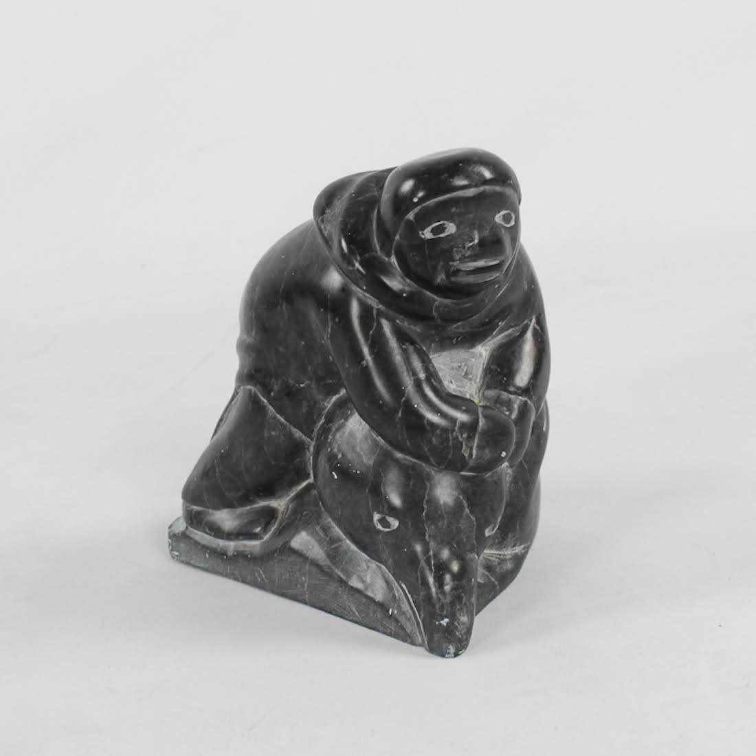 Inuit Hand-Carved Stone Sculpture Attributed Kapik: A vintage Inuit hand-carved soapstone sculpture. This work depicts a man draped over the head of a large bird. It is labeled "Canada Eskimo Art" on the underside. Possibly Kapik Kolola. Dimensions: 6.