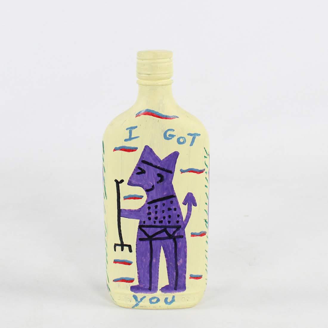 Folk Art Devil Liquor Bottle by Robert Miller: A hand-painted liquor bottle by folk artist Robert Miller (son of R.A. Miller.) This work depicts the devil with a pitchfork in hand and reads "I got you" on one side and "You no it" on the other. It 