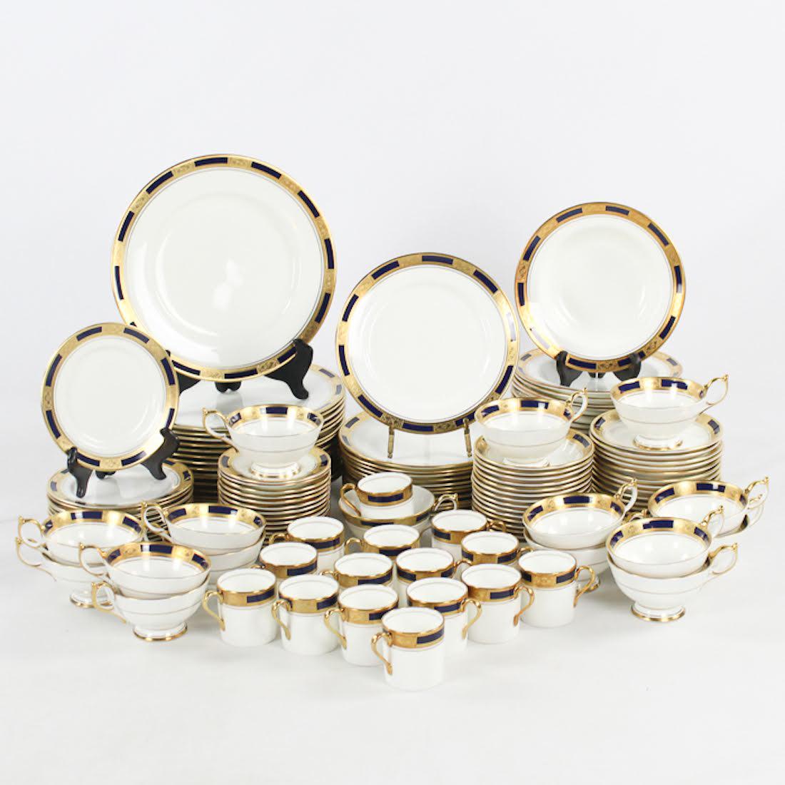 Aynsley "Empress Cobalt" China Service for Fifteen: A bone china service for fifteen by John Aynsley. This set features the "Empress Cobalt" pattern. Each piece showcases an ornate gilt and cobalt rim over a white base and is marked on the underside. T