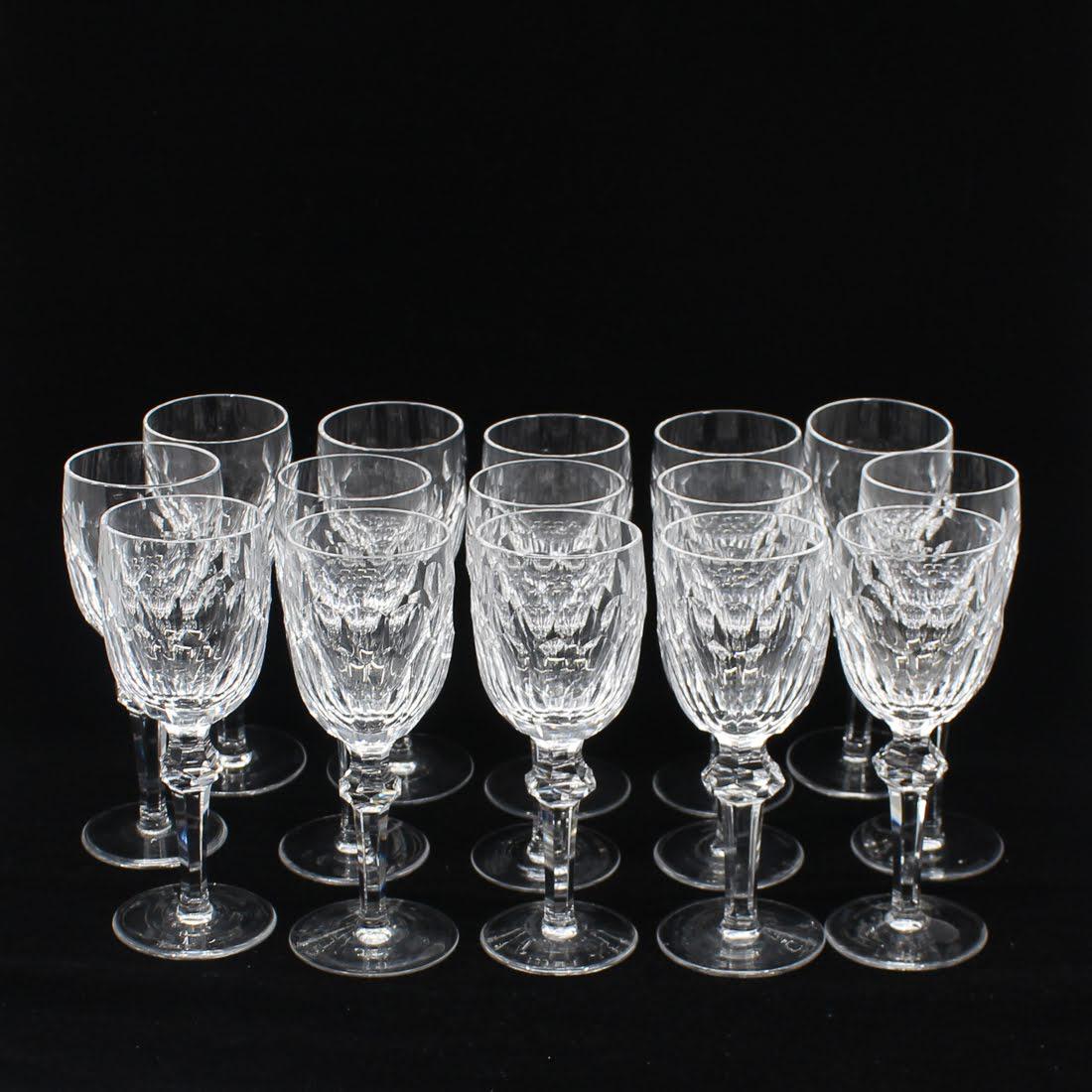 Waterford "Curraghmore" White Wine Glasses: A set of fourteen Waterford crystal white wine glasses. These glasses feature the "Curraghmore" pattern. Each is marked "Waterford" on the underside. One extra glass is included with the set. Dimensio