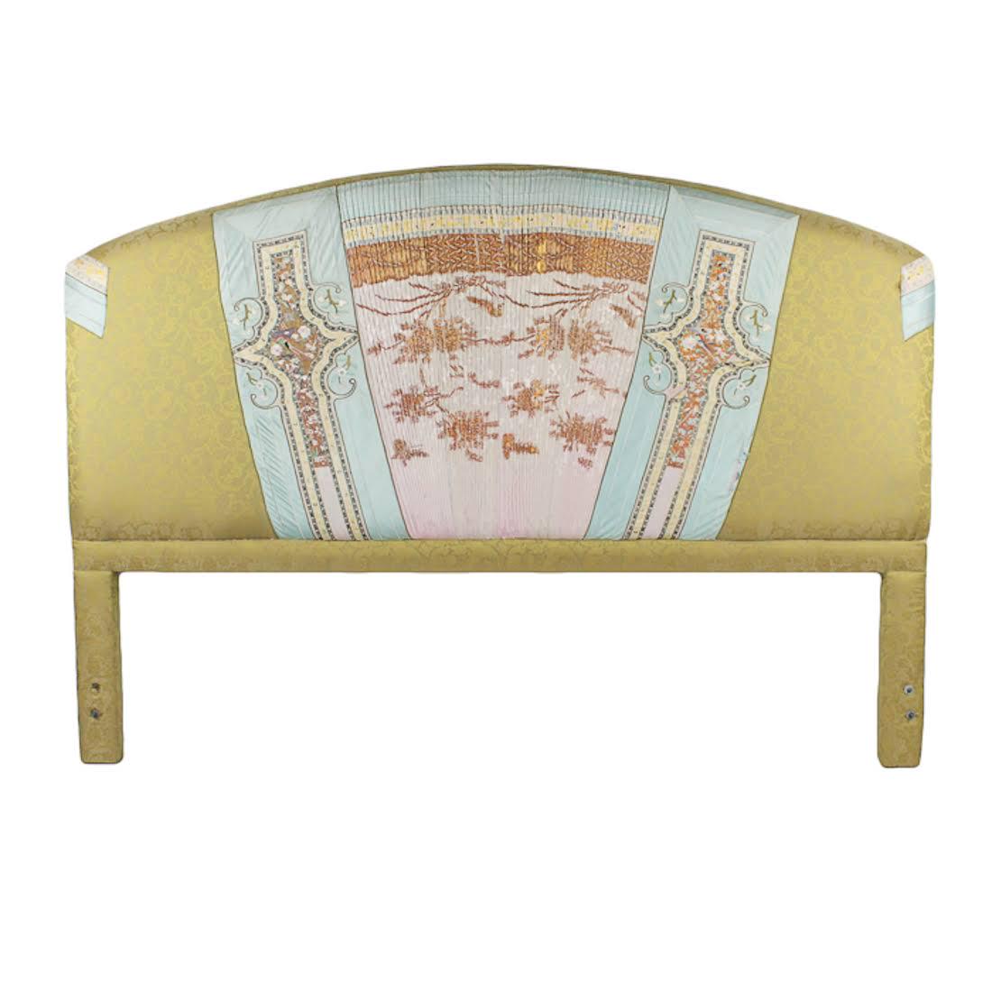 Antique Chinese Silk Forbidden Stitch Embroidery: An antique Chinese upholstered headboard. This piece features panels of baby blue and pink silk over golden acanthus patterned fabric. These panels fan outwards in the center and cap the shoulders of