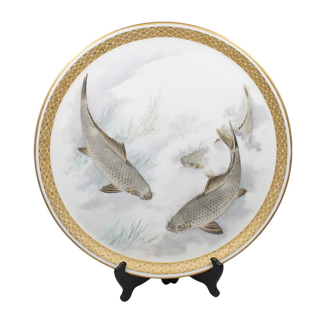 Antique Meiji Period Japanese Satsuma Enamel Platter: An antique Japanese hand-painted Satsuma Enamel porcelain platter. This piece features a hand-painted design of three grey koi fish in the center and is completed with a gilt border. The underside fea