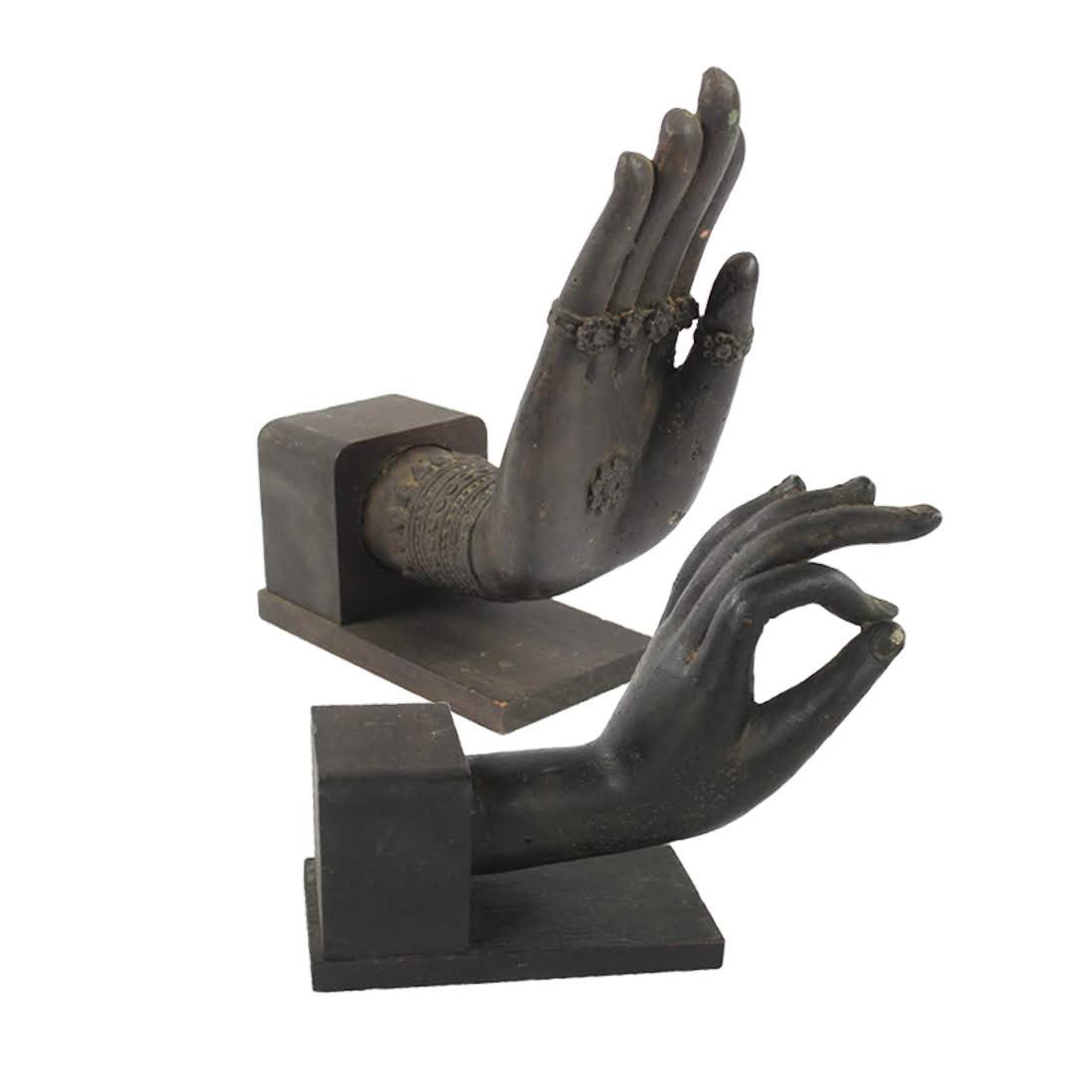 Pair of Buddhist Mudra Hand Statues: A pair of vintage iron Buddhist mudra hand statues with a wooden bases. Each hand is decorated with a bodhi flower at the center of the palm. They are unmarked. Dimensions: 7.25 x 5.5 x 3 Flat Rate Sh