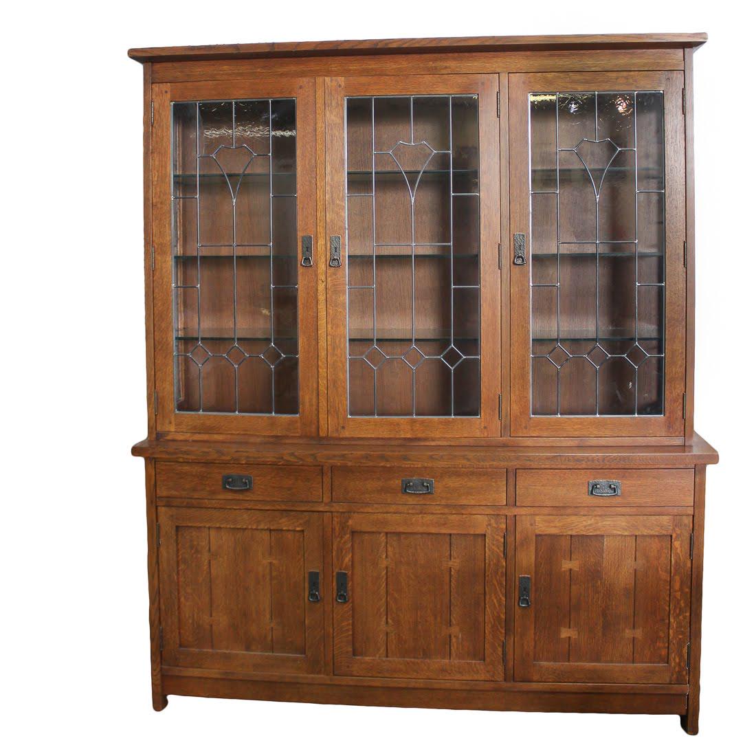 Stickley Mission Collection Lighted Oak China Cabinet: A Stickley Mission Collection oak buffet with a lighted china top. The buffet portion features three doors accented with butterfly joinery. Above these doors are three small drawers, each featuring do