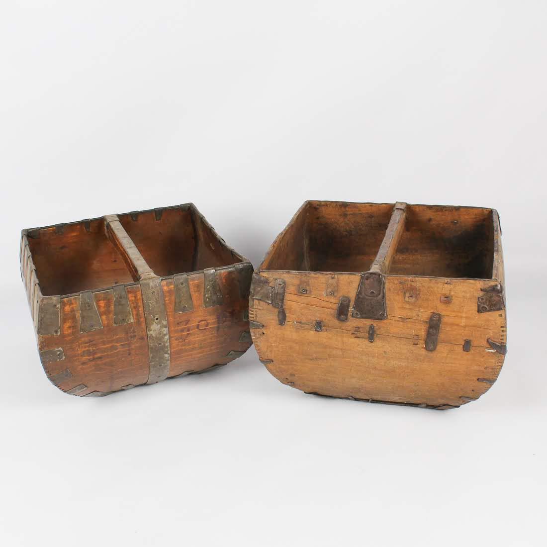 Antique Chinese Dou Primitive Grain Baskets: A grouping of two antique Chinese primitive dou grain baskets. Each piece is constructed of four bentwood side panels, one flat bottom panel, and a straight handle. They feature tight dovetail joints 