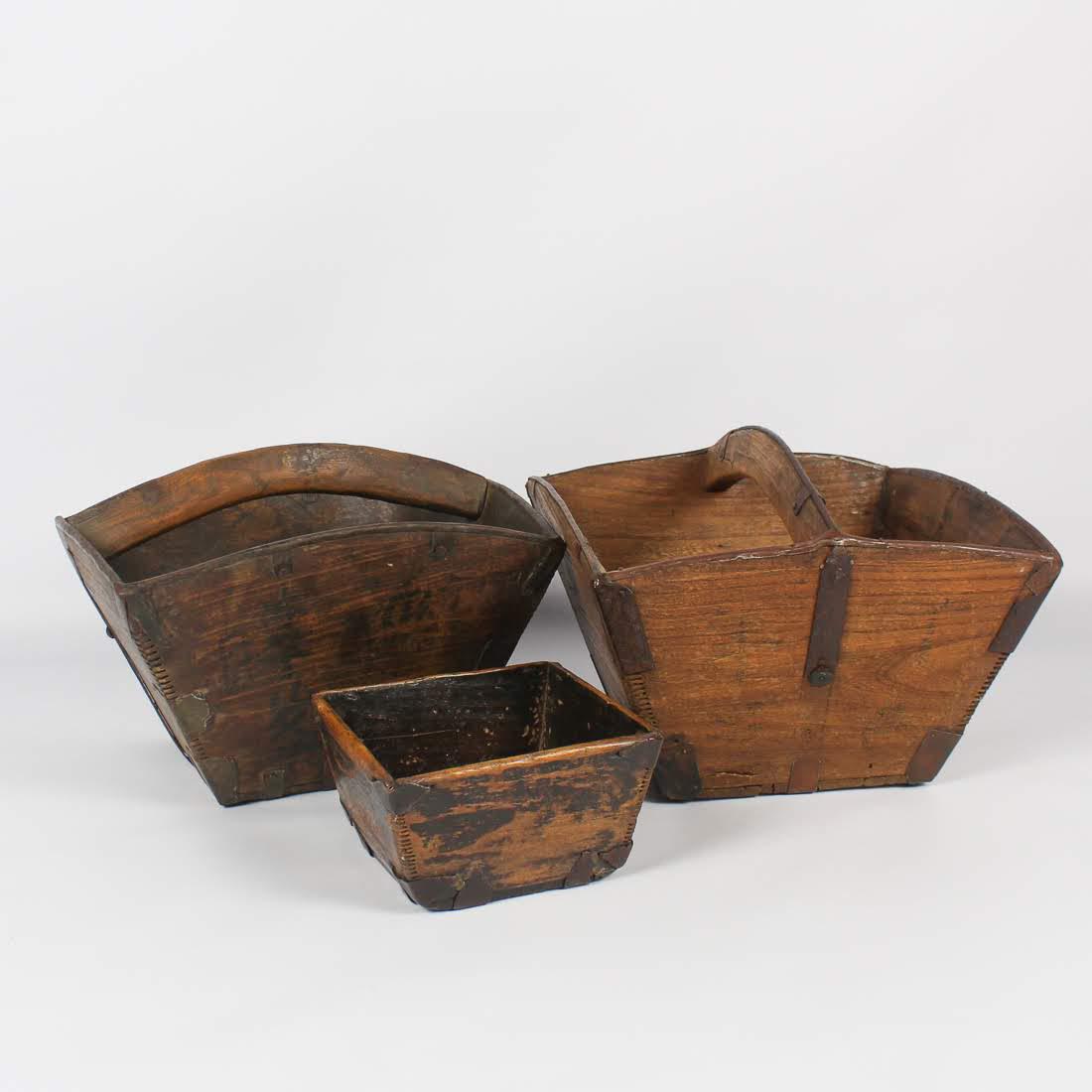 Antique Chinese Primitive Dou Grain Baskets: A grouping of three antique Chinese primitive dou grain baskets. Each features a tapered form and is constructed of four flat side panels and one flat bottom panel. Two have bentwood handles and the o