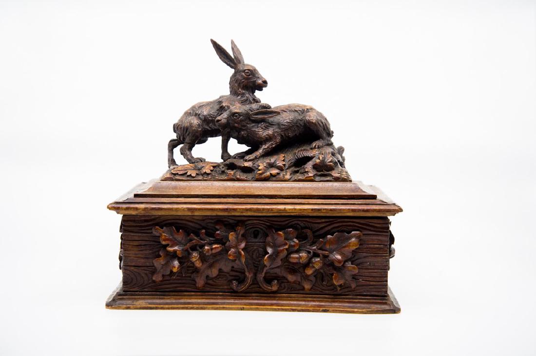 Antique Black Forest Rabbit Hare Jewelry Box: This beautiful Black Forest jewelry box comes from a high end estate in Atlanta, GA. The piece features a 3D rabbit carving motif on top and raised holly berry patterns on sides. The lid has an antiqu