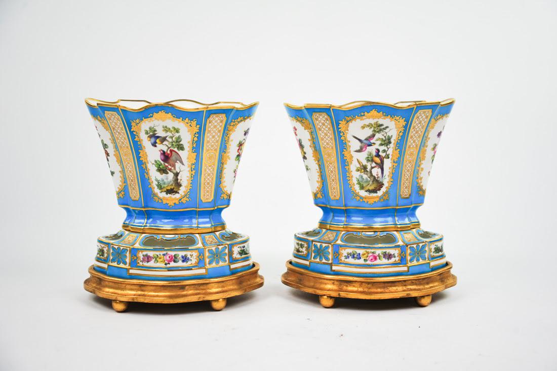Pair of Antique Sèvres Vases by Minton: A pair of early 19th Century antique Sèvres vases by Minton with giltwood bases. Each vase features hand-painted flora and fauna designs over a turquoise ground with gilt detailing throughout and dec