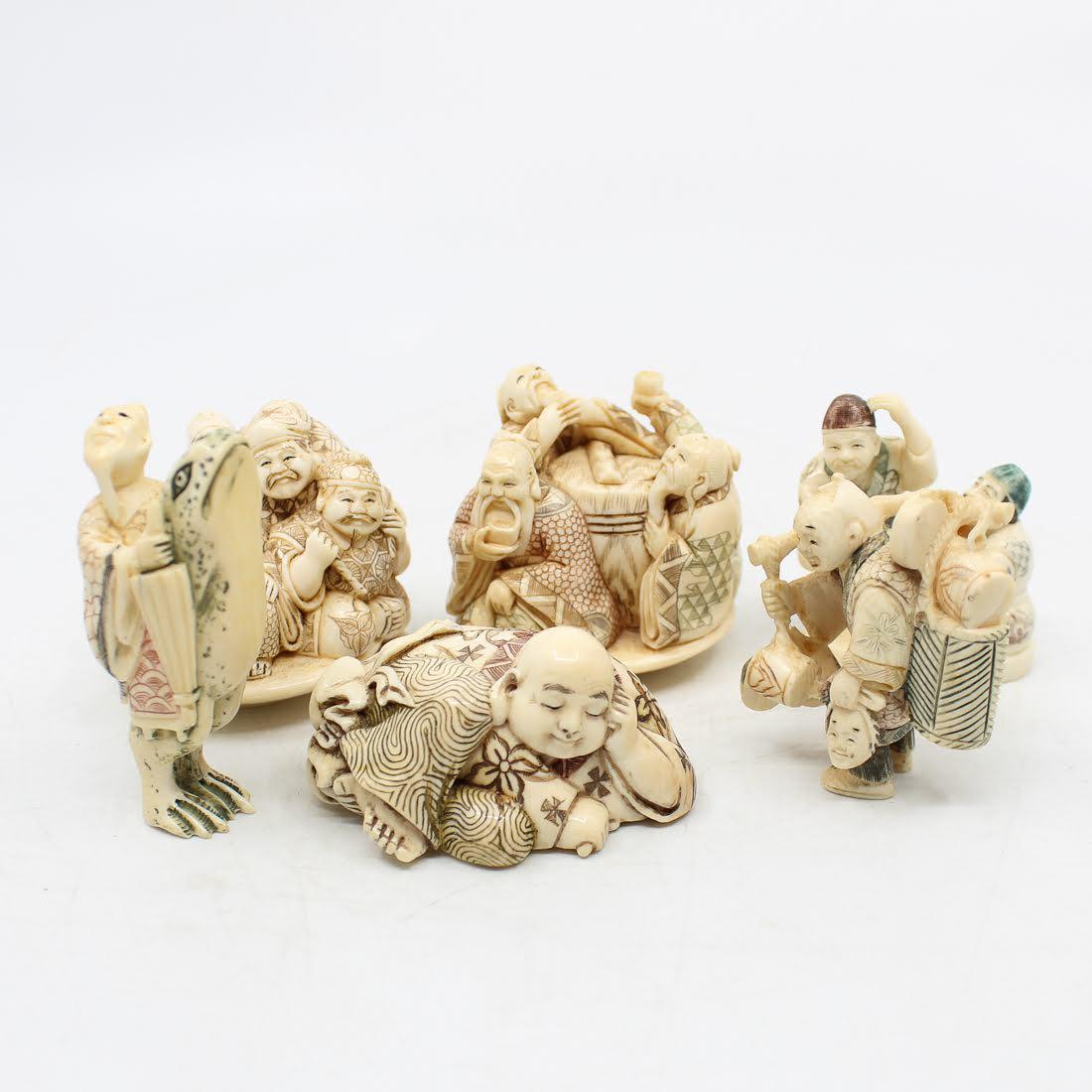 Antique Japanese Carved Bone Netsukes: A grouping of six antique Japanese carved bone netsukes. Each features etched detailing throughout and is marked on the underside. The wooden stands are not included. Dimensions: 2 x 2.25 x 2.25 (for 