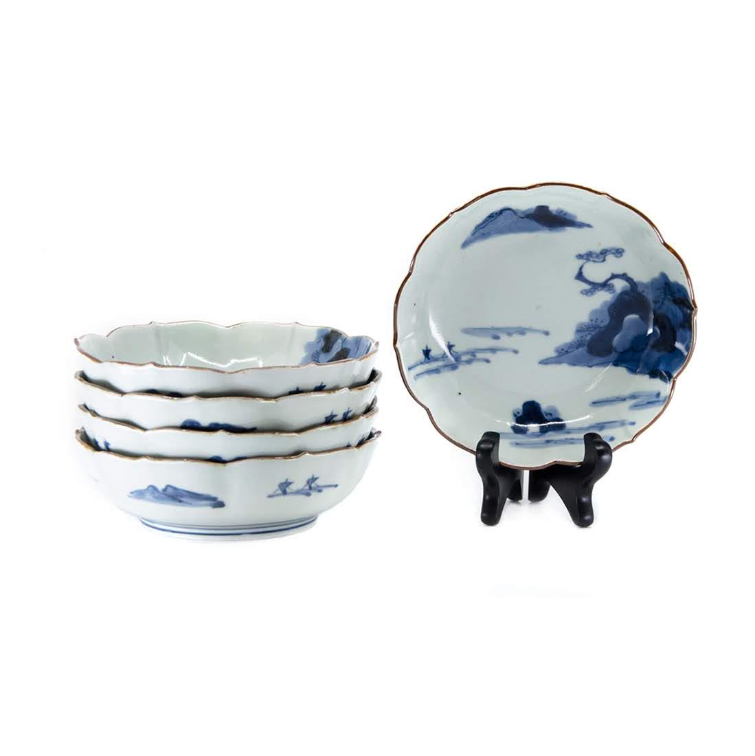 Set of Five Antique Imari Blue and White Porcelain: A set of five antique Imari blue and white porcelain bowls. Each bowl features a scalloped rim and is decorated with depictions of mountains and trees on the interior and on the underside. Each is mar