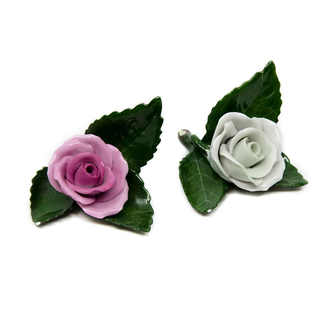 Herend Hungary Porcelain Rose on Leaf Figurines - 8983: A pair of Herend Hungary porcelain rose on leaf figurines. One flower is hand-painted white and the other pink with green leaves. Both pieces are marked with Herend's maker's mark and numbered "8983"
