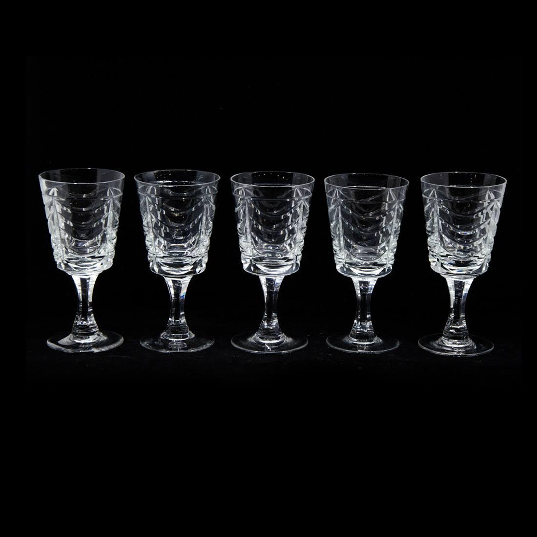 Set of Twenty Brierley Crystal Red Wine Glasses: A set of twenty Brierley crystal red wine glasses. Each glass features a repeating drape design throughout the body. They are marked "Brierley" on the underside. The pattern number for this set is RBR