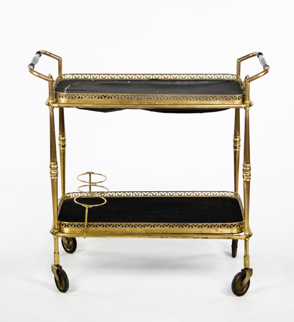 Antique Brass Bar Cart: An antique brass bar cart. This piece features two layers, each of which holds a tray with pierced sides and black felt lining. It rests on four castor wheels and is unmarked. Dimensions: 28"H x 29"W