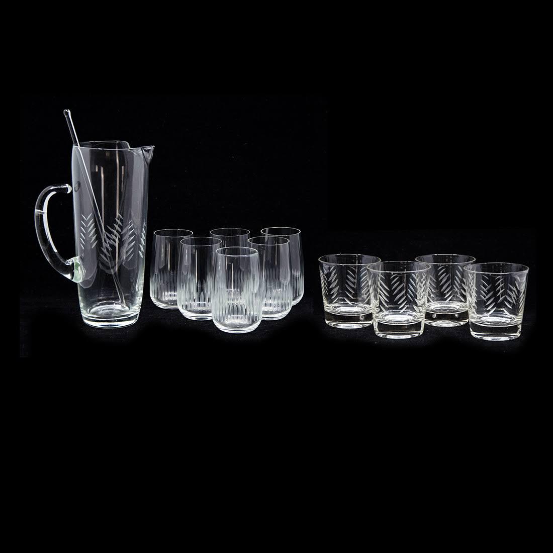 Collection of Crystal Glassware: A collection of crystal glassware. This lot includes a pitcher with a stirrer, a set of six water glasses, and a set of four lowball glasses. Dimensions: 9"H x 6"W x 4"D (for pitcher); 4"H x 2.5"W x 2