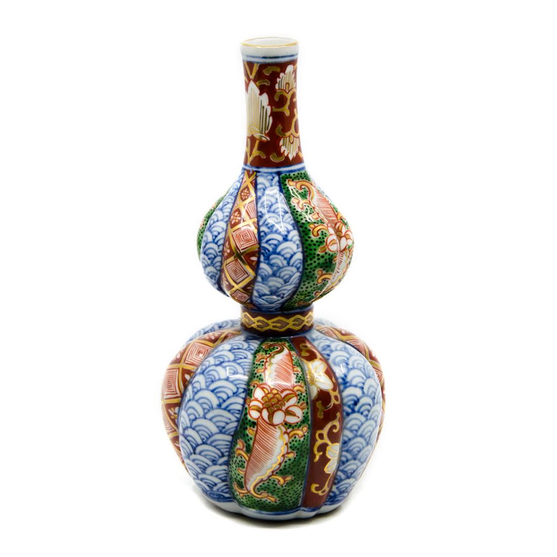 Antique Imari Hand-Painted Porcelain Vase: An antique Imari hand-painted porcelain vase. This piece features a double gourd form. It is decorated throughout with hand-painted floral, foliate, and geometric motifs in a palette of blue, green, r