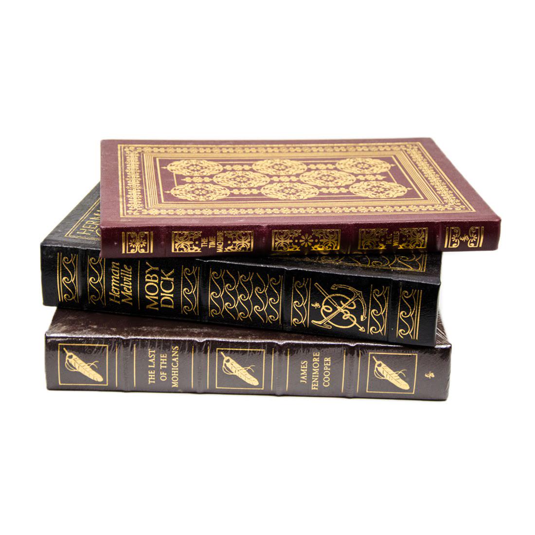 Gilded Leather-Bound Books Published by Easton Press: A grouping of three gilded leather-bound books. This lot includes "The Last of The Mohicans" by James Fenimore Cooper (Easton Press; Connecticut; 1979), "The Time Machine" by H.G. Wells (Easton Press;