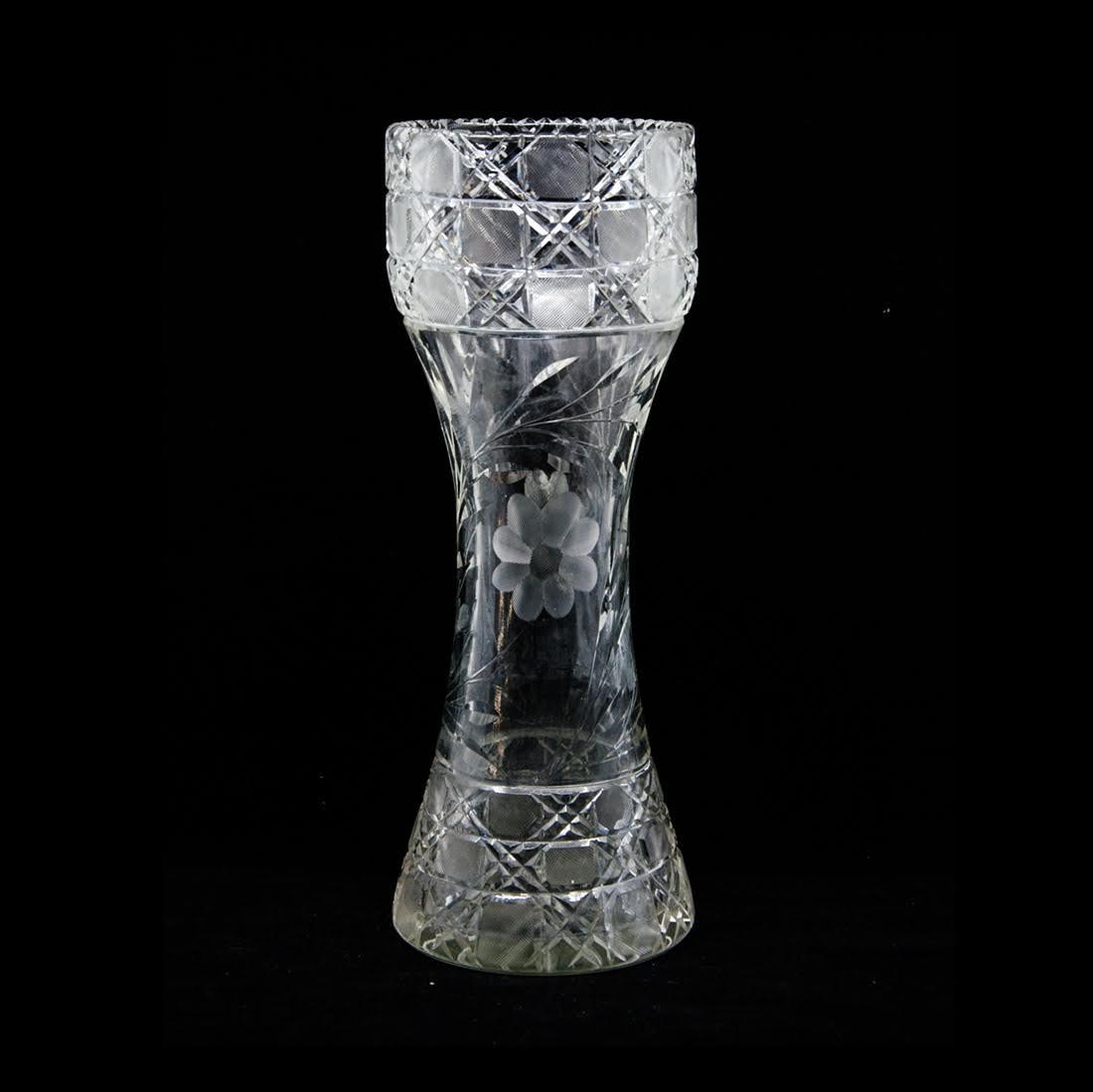 Antique Crystal Vase: An antique crystal vase. This piece features a crosshatch pattern at the top and bottom and a floral design through the center. It is unmarked. Dimensions: 14.25"H x 5.25"W x 5.25"D