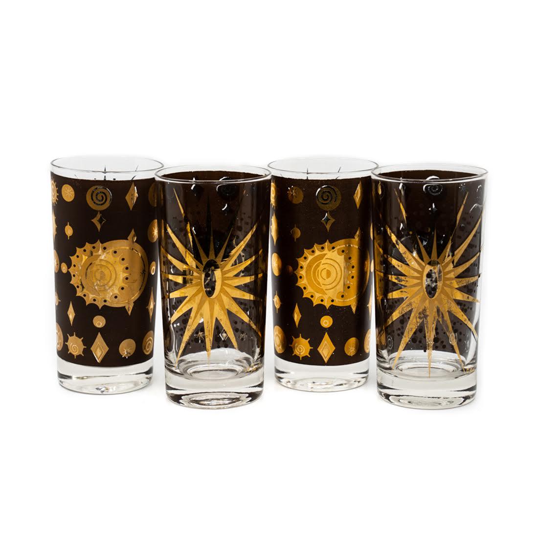 Set of 4 Fred Press 22k "Atomic Starburst" Glasses: Set of four 1950â€™s Fred Press MCM highball cocktail glasses featuring the Atomic Starburst pattern in 22k gold accents. Opposite of the starburst pattern, the glasses are painted dark brown wit