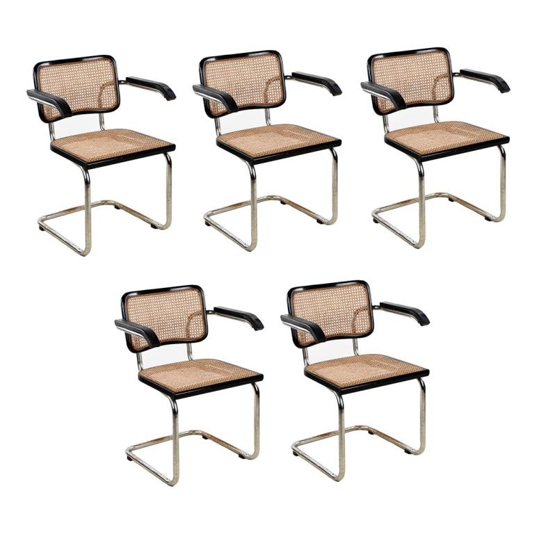 Set of 5 Breuer Cesca B32 Cantilever Chairs: A set of five Cesca B32 cantilever armchairs by Marcel Breuer for Knoll. Chairs feature chrome steel frames with black wooden frames and inset cane woven backs and seats. They are marked "Made in Ital