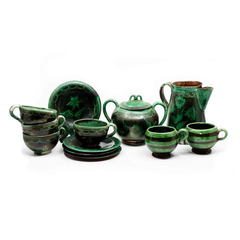Group of 13 Green Hand-Painted Folk Art Ceramic Coffee: Group of thirteen green hand-painted folk art ceramic coffee set. Set includes: four cups and saucers, two small tea cups, sugar bowl with lid, and coffee carafe. Carafe measures 6.5" x 6" x 5".