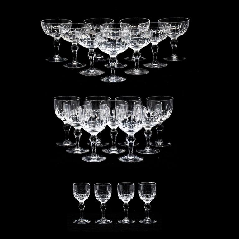 Group of 23 Stuart (England) Crystal Glassware: Group of 23 Stuart (England) crystal glassware. Group includes: ten champagne coupes, nine white wine goblets, and four cordial glasses. "Stuart, England" etched on bottom of each piece. Champagne Cou