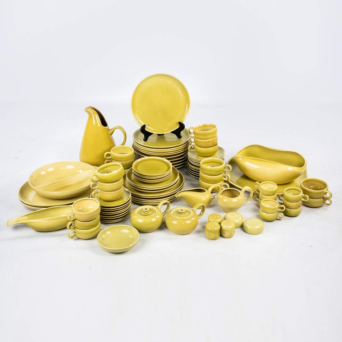 MCM 88 Piece Olive Green Glazed Stoneware China Set by: Mid-century Modern 88 piece olive green glazed stoneware china set by Russel Wright (Mfg. by Steubenville). Each piece is marked. Large plate // Saucer measures: 10" // 6".