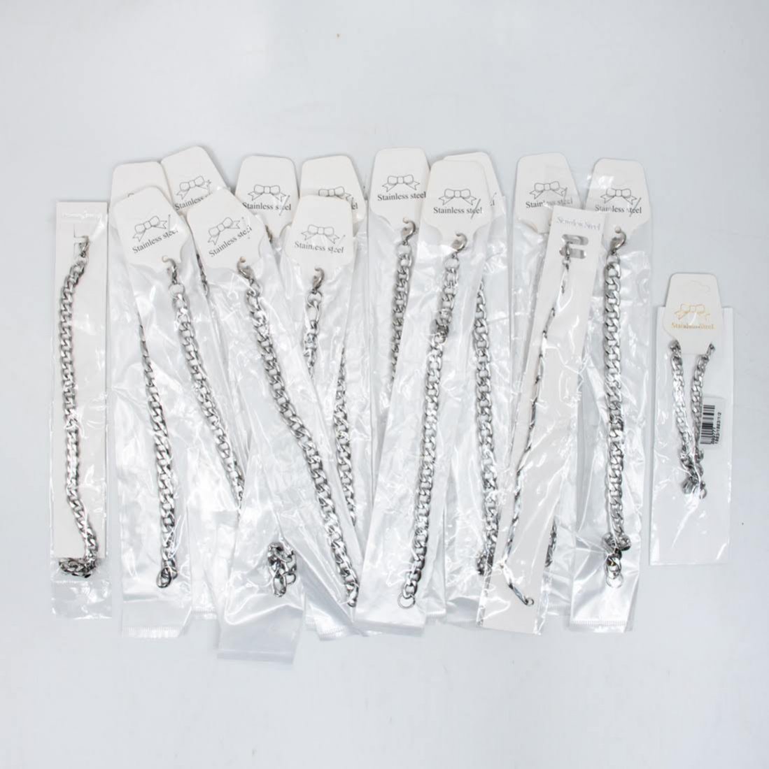 Fifteen Stainless Steel Link Chain Bracelets: A group of 15 stainless steeel link chain bracelets. Fashion jewelry is in original packaging. 7" L