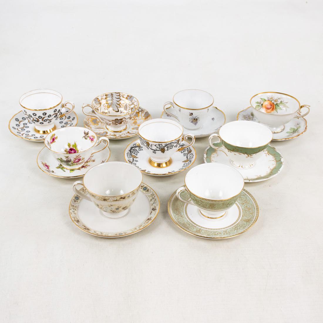 Group of 9 Porcelain Tea Cups and Saucers: A group of 9 antique porcelain tea cups and saucer sets with floral, fruit, and gilt accented patterns. Each teacup is marked on the bottom and origins vary.