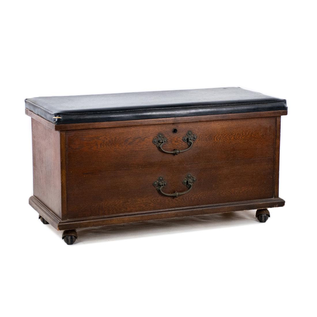 Lane Altavista Cedar Chest and Bench: A mid-century Lane Altavista cedar chest with two faux drawers and a black vinyl upholstered bench seat. It features metal decorative hardware and sits atop four castor wheels. It is marked on the int