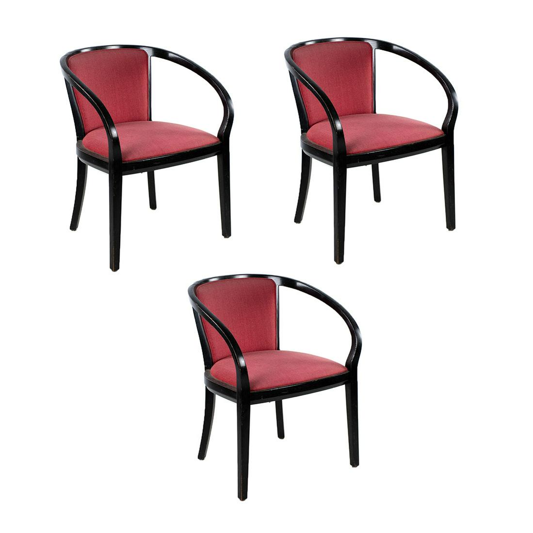 Set of 3 Ruby Armchairs by Knoll: A set of three black waxed ash Ruby armchairs designed by Ward Bennett and manufactured by Knoll. They feature ruby red upholstery and unique curved arms. They were originally used in the Coca-Cola Co