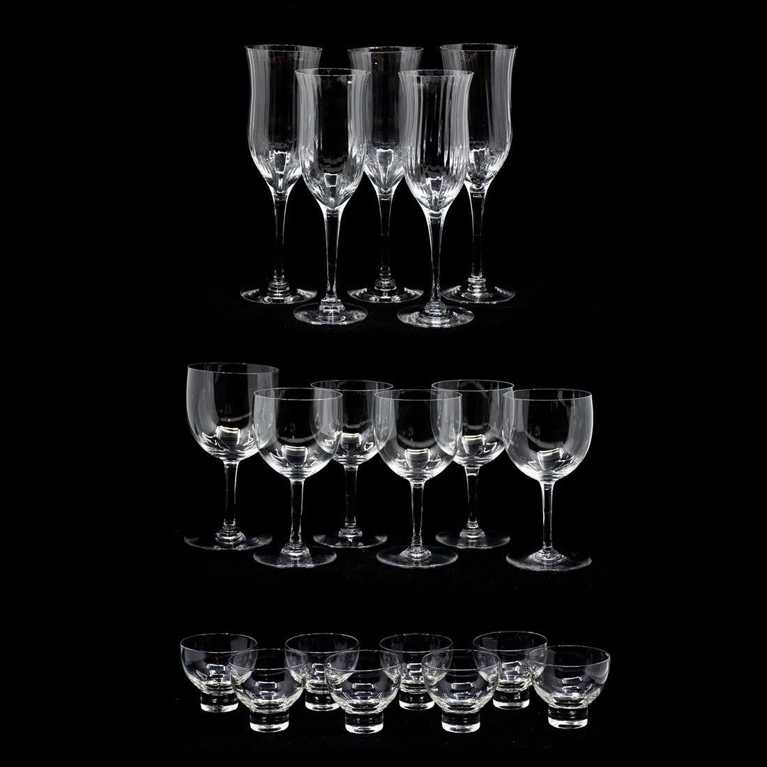 Group of Baccarat and Orrefors Crystal Glasses: Group of 19 crystal stemware and glassware by Baccarat and Orrefors, small brandy glasses are unmarked. Champagne flutes measure: 9.5 x 2.75 x 2.75, wine glasses: 6.5" x 3" x 3, and brandy glasses: 2.