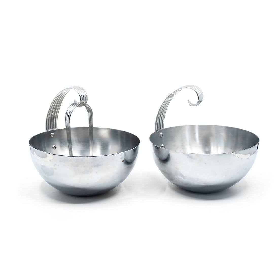 2 Russel Wright for Chase Chrome Ice Bowls: Group of 2 chrome ice bowls (one with tongs) designed by Russel Wright for Chase. Group includes two bowls with side hook for resting tongs, and pair of serving tongs. All bowls are in good condition