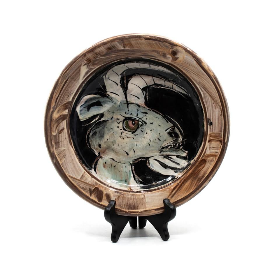 Ron Meyers Pictorial Ceramic Hand Thrown Goat Plate: A hand thrown painted pictorial art pottery plate depicting a cartoon stylized goat by artist Ron Meyers. Dimensions: 2"x 10"DIA. Ron Meyers has been in clay for over 30 years, known for his loose, wh