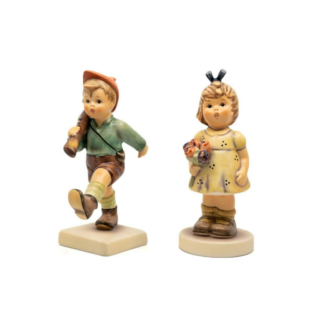Group of 8 Goebel Hummel Figurines: A group of 8 Goebel Hummels including #795/0 From My Garden TMK 7 figure, featuring a girl with a bouquet of flowers in her hand and #720 On Parade TMK 7 figure, featuring a young boy marching with a