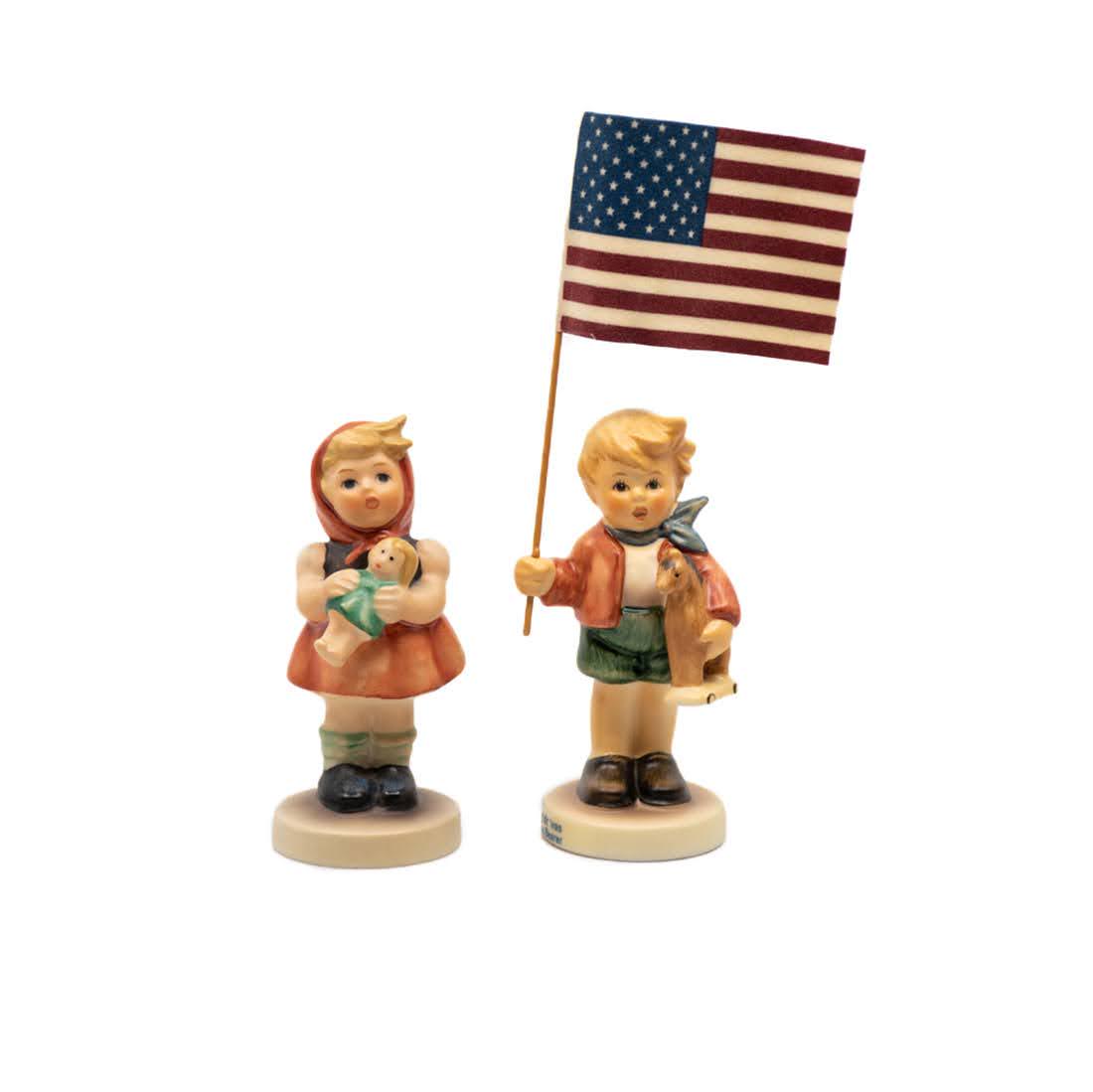 Goebel Hummel Girl with Doll 239/B and Little Flag: Goebel Hummel #239/B Girl with Doll TMK 8 figure, featuring a young girl carrying her doll and #239/E Little Flag Bearer TMK 8 figure, featuring a boy with a horse in one hand and a flag in the other.