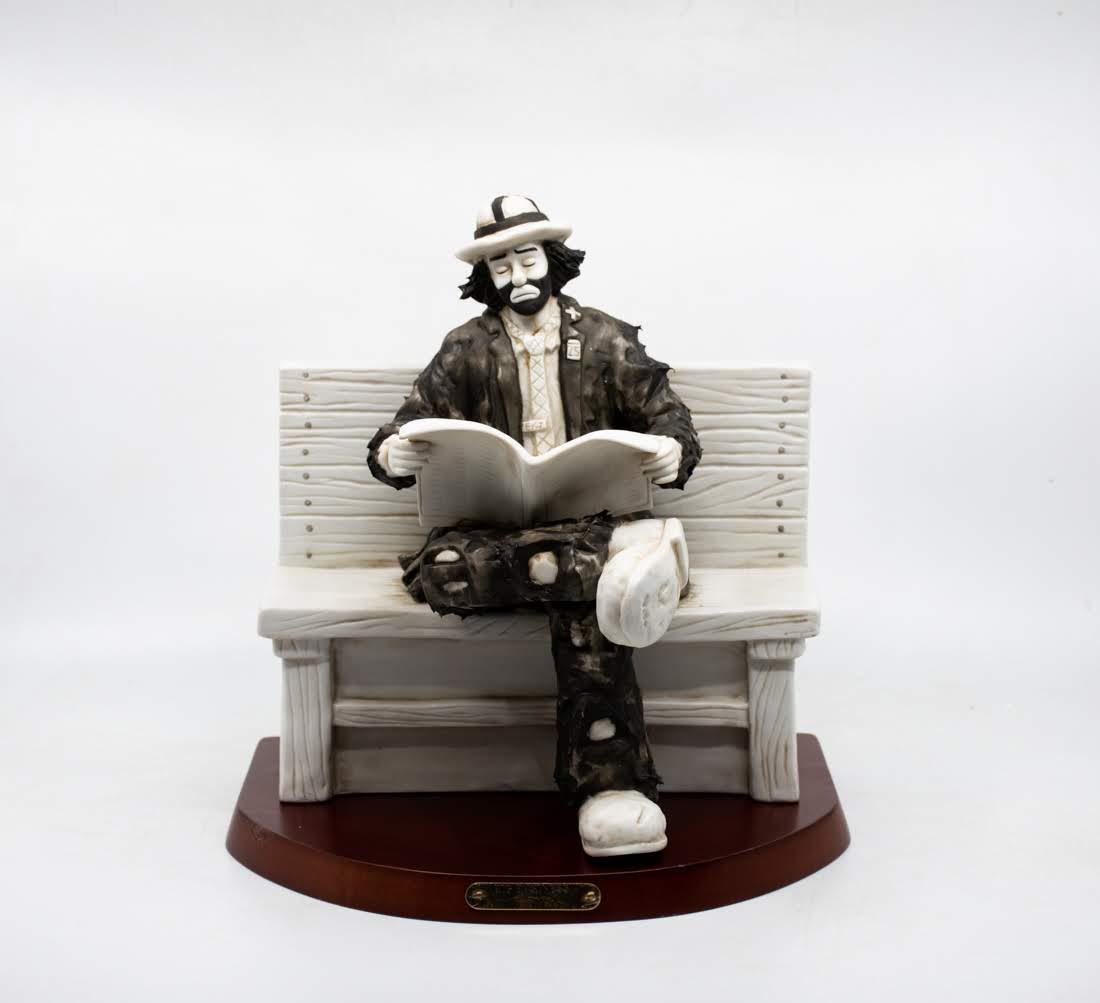 Emmett Kelly Jr "Big Business" Clown: An Emmett Kelly Jr "Big Business" Clown figure, featuring a black and white tone clown sitting on a bench with the newspaper and his eyes closed. It is marked on the underside Limited Edition No. 0891
