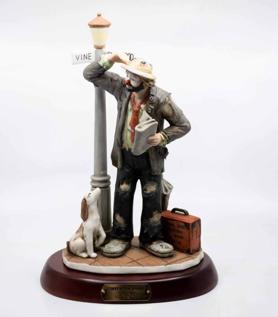 Emmett Kelly Jr "Convention Bound" Clown: An Emmett Kelly Jr "Convention Bound" Clown figure, featuring a clown with the newspaper in his hand looking for the next bus. It is marked on the underside 4644/7500.