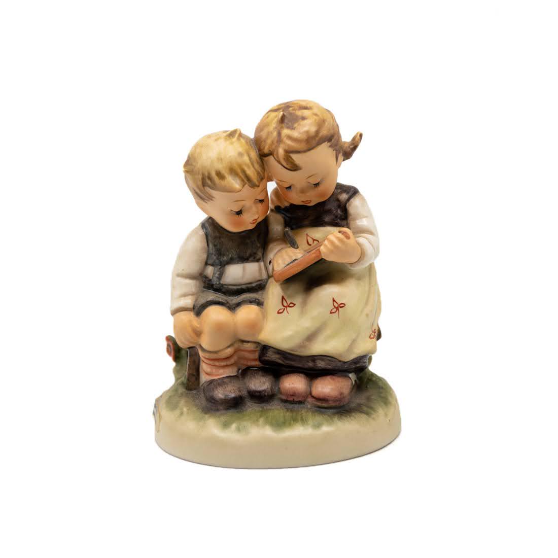 Goebel Hummel The Smart Little Sister 346 Figurine: Goebel Hummel #346 The Smart Little Sister TMK 6 figure, featuring a young girl reading a book to her younger brother. It is signed by the artist.